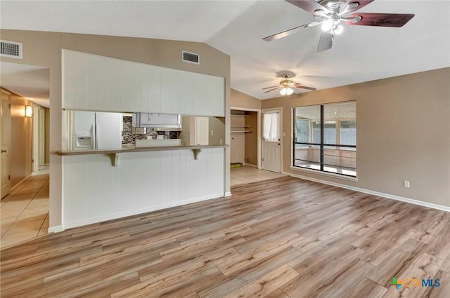 105 Concord Ln, Victoria, TX 77901 - unfurnished living room featuring vaulted ceiling, a ceiling fan, light wood-type flooring, and baseboards