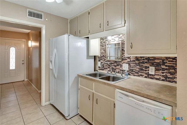105 Concord Ln, Victoria, TX 77901 - kitchen with white appliances, light tile patterned floors, a sink, decorative backsplash, and light countertops