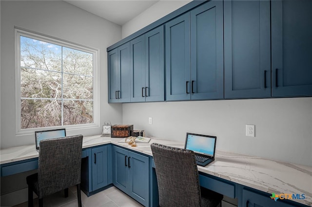 tiled home office featuring built in desk