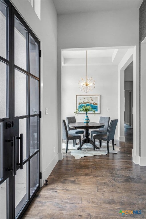 dining room featuring dark hardwood / wood-style floors and a chandelier