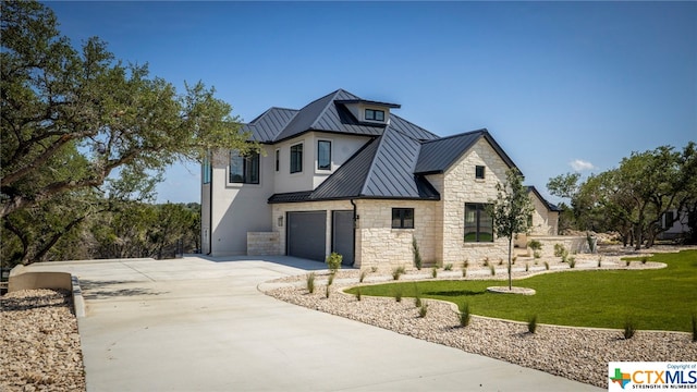 view of front facade with a garage and a front yard