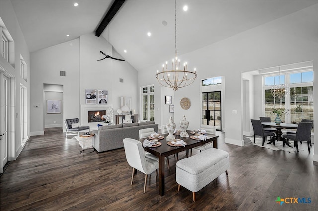 dining space with beam ceiling, a wealth of natural light, and dark hardwood / wood-style flooring