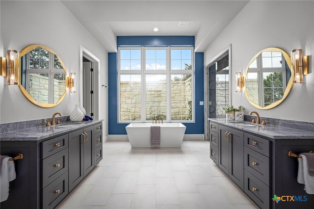 bathroom featuring vanity and a bath