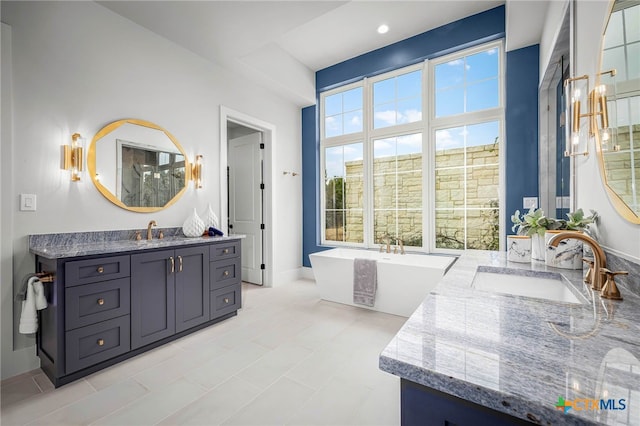 bathroom with vanity and a tub to relax in