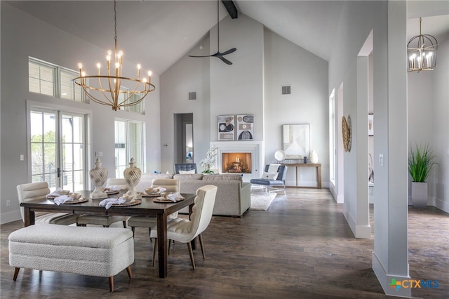 dining room with dark hardwood / wood-style floors, beam ceiling, and a notable chandelier