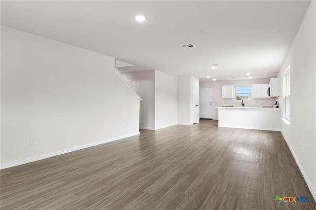 3816 Poteet Ct, Temple, TX 76504 - unfurnished living room featuring dark wood finished floors and recessed lighting