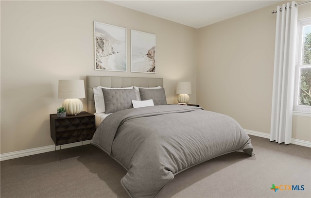 carpeted bedroom featuring multiple windows