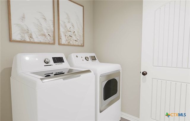 washroom with washing machine and dryer