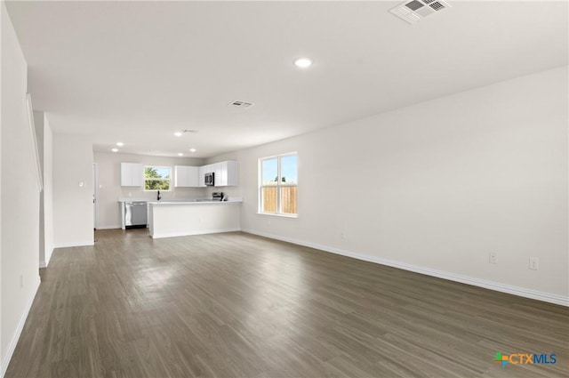 3816 Poteet Ct, Temple, TX 76504 - unfurnished living room featuring dark wood-style floors and recessed lighting