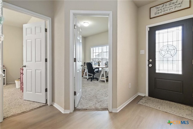 foyer with light hardwood / wood-style floors