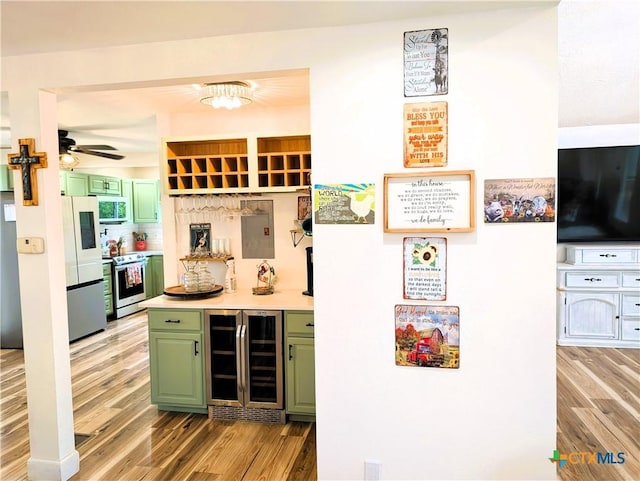 127 Forest Mist, Canyon Lake, TX 78133 - bar featuring beverage cooler, freestanding refrigerator, light wood finished floors, stainless steel electric stove, and a dry bar