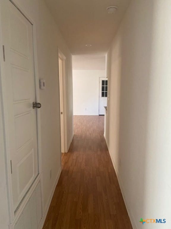 corridor featuring dark hardwood / wood-style floors