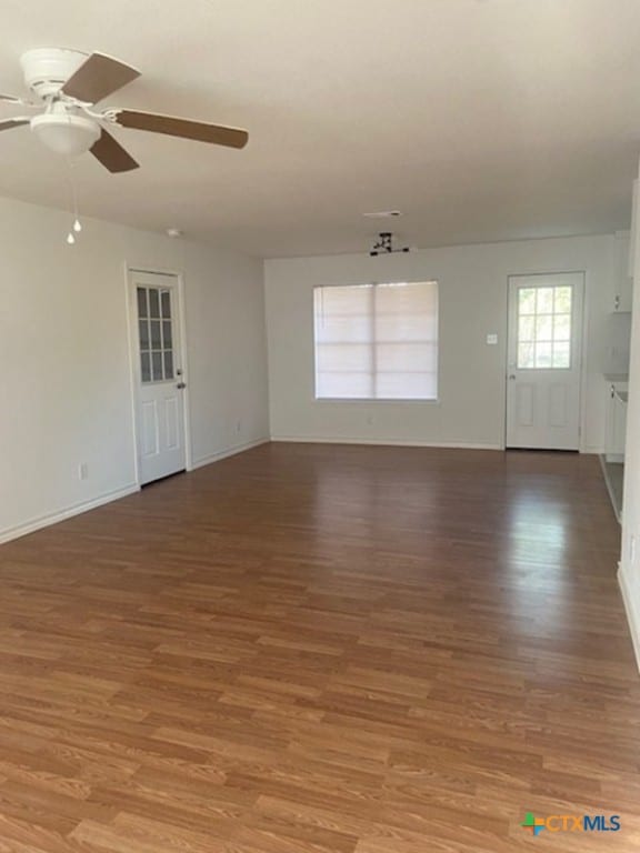 unfurnished room featuring ceiling fan and hardwood / wood-style floors