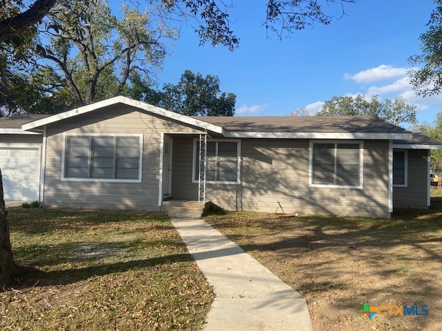 single story home with a front lawn and a garage