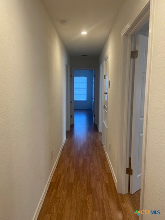 corridor featuring dark wood-type flooring