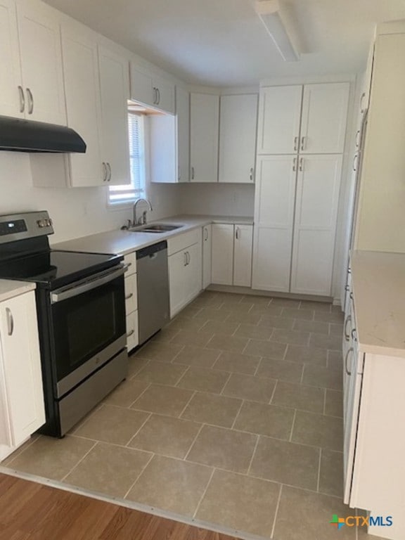 kitchen with white cabinets, stainless steel appliances, and sink