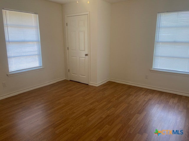 empty room featuring wood-type flooring