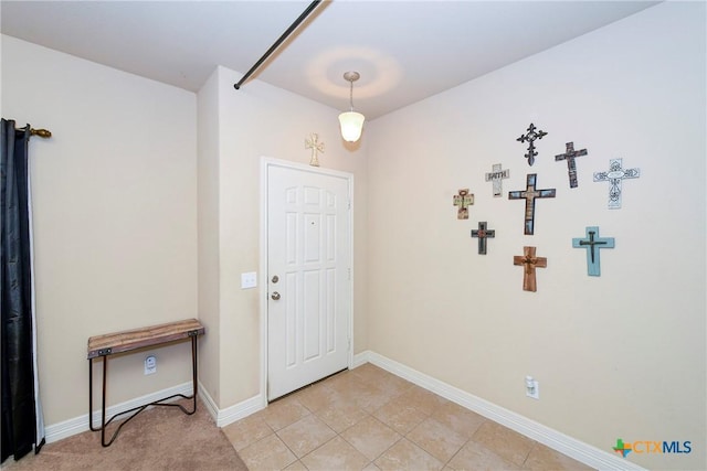 foyer with baseboards and light tile patterned floors