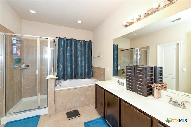 full bath featuring a stall shower, tile patterned flooring, a garden tub, double vanity, and recessed lighting