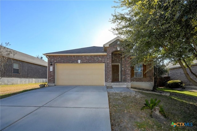 view of front of property featuring brick siding, a garage, and concrete driveway