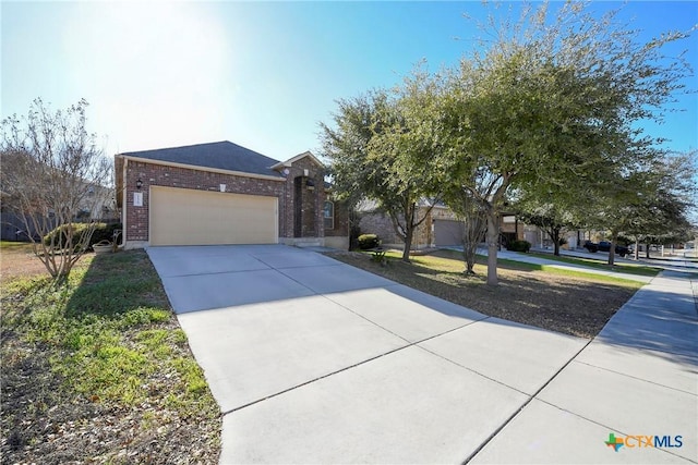 view of front of home featuring brick siding, an attached garage, and concrete driveway