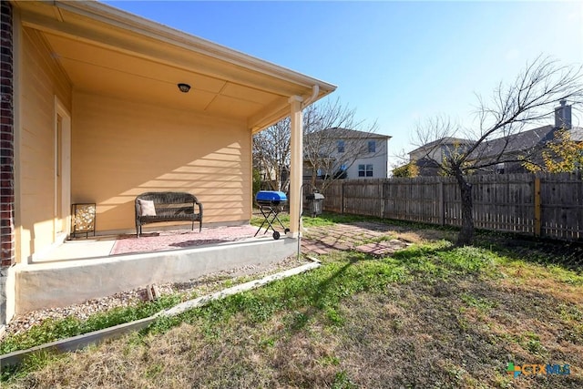view of yard with fence and a patio area