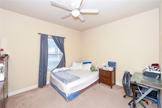 bedroom with light carpet, baseboards, ceiling fan, and a desk