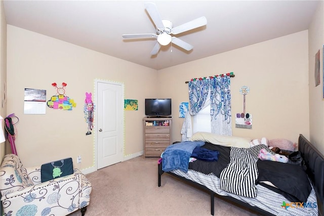 carpeted bedroom featuring baseboards and ceiling fan