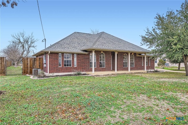 ranch-style house featuring central AC unit and a front lawn