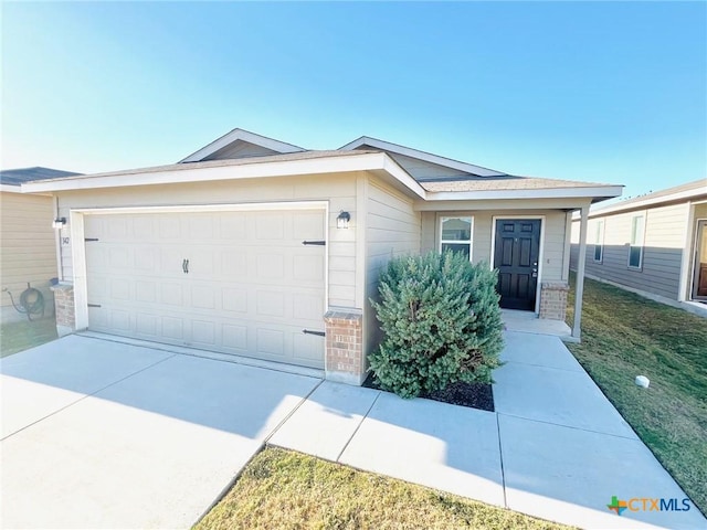 single story home with a garage and a front lawn