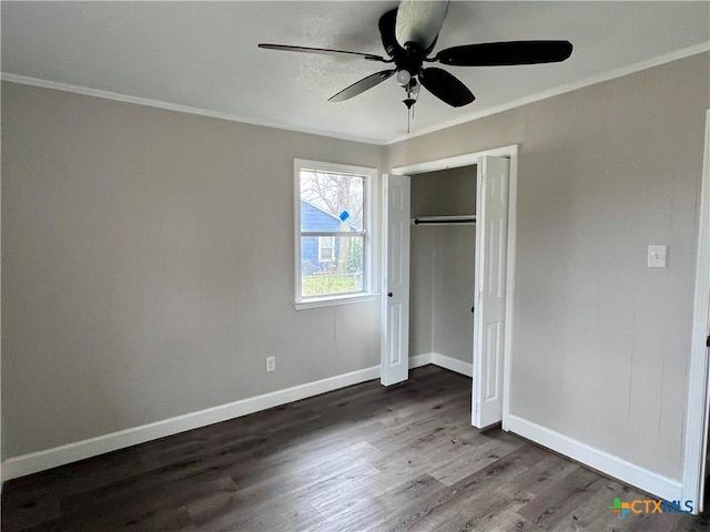 unfurnished bedroom with ceiling fan, a closet, dark wood-type flooring, and ornamental molding