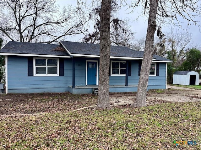 single story home with a storage shed and a front lawn