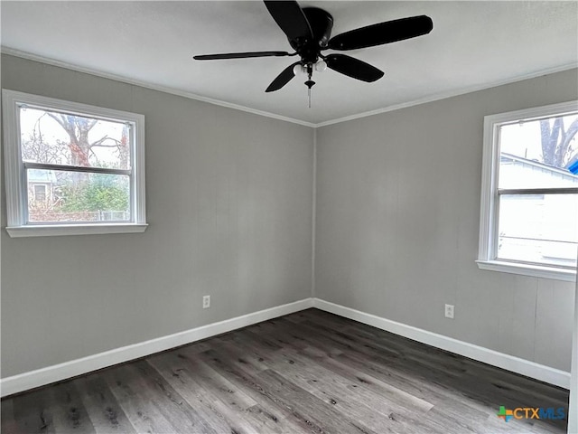 spare room featuring dark hardwood / wood-style floors, crown molding, ceiling fan, and a healthy amount of sunlight