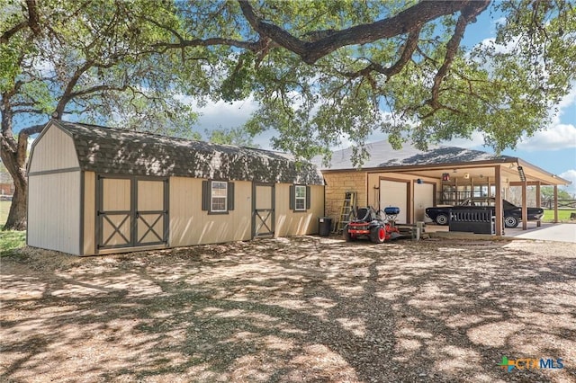 103 Misty Bnd, Floresville, TX 78114 - exterior space with dirt driveway, an attached garage, and an outbuilding