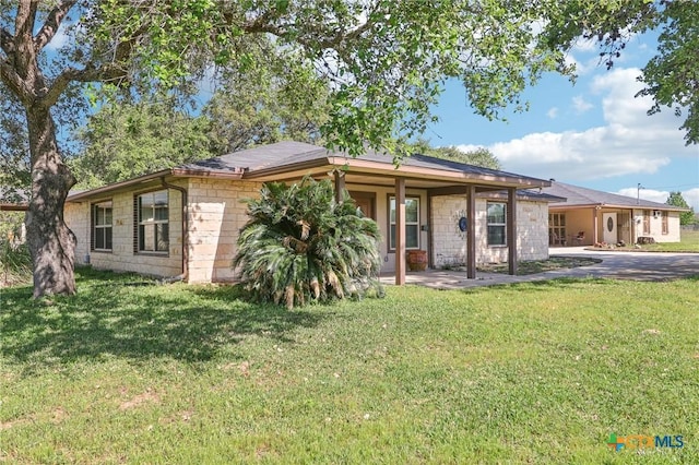 103 Misty Bnd, Floresville, TX 78114 - back of house with a yard and stone siding