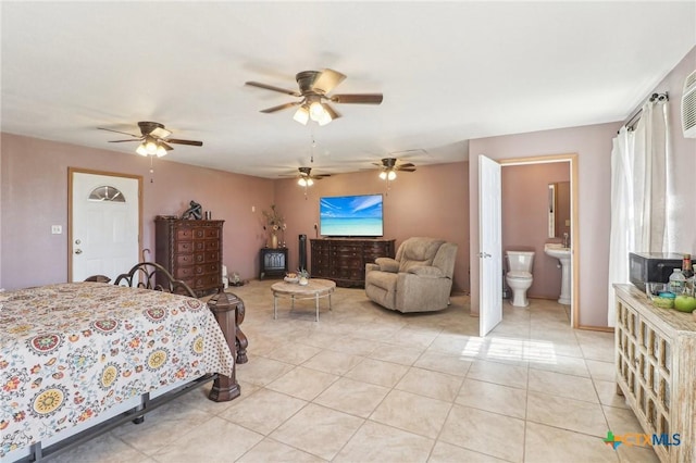 103 Misty Bnd, Floresville, TX 78114 - bedroom with ceiling fan, ensuite bath, and light tile patterned flooring