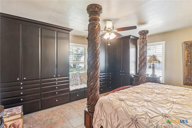 103 Misty Bnd, Floresville, TX 78114 - bedroom with a textured ceiling, light tile patterned flooring, and ceiling fan