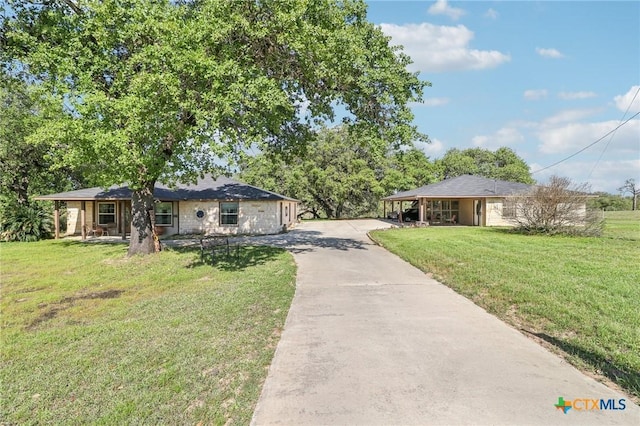 103 Misty Bnd, Floresville, TX 78114 - single story home with concrete driveway, a carport, and a front lawn