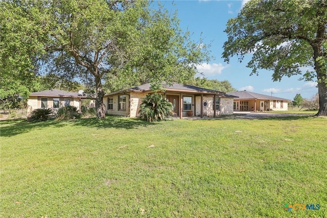 103 Misty Bnd, Floresville, TX 78114 - rear view of house featuring a yard