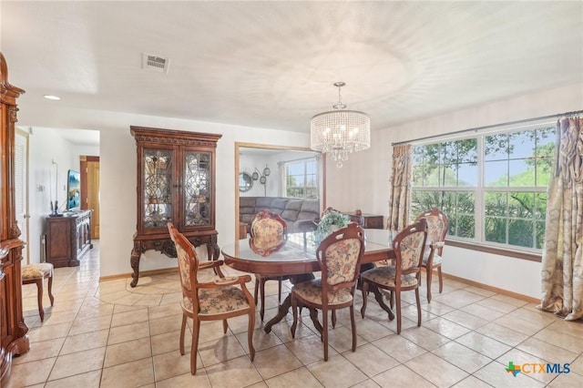 103 Misty Bnd, Floresville, TX 78114 - dining room with light tile patterned floors, a notable chandelier, visible vents, and baseboards