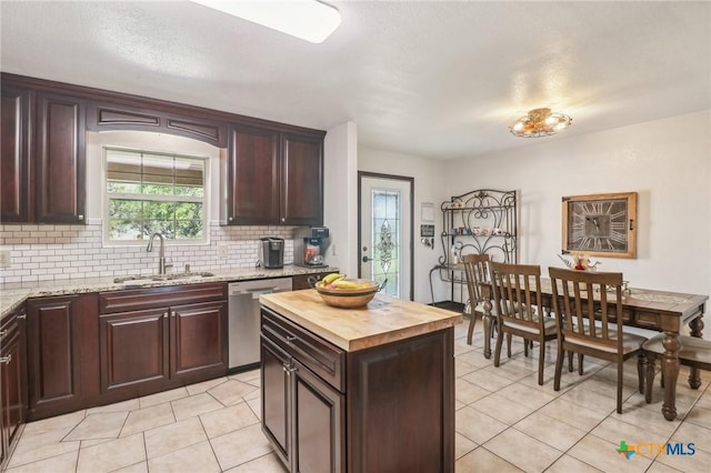 103 Misty Bnd, Floresville, TX 78114 - kitchen with wooden counters, light tile patterned flooring, a sink, and dishwasher