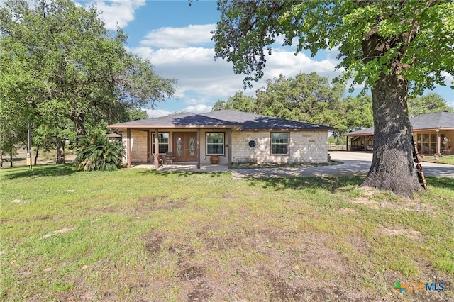 103 Misty Bnd, Floresville, TX 78114 - rear view of property featuring a yard and stone siding