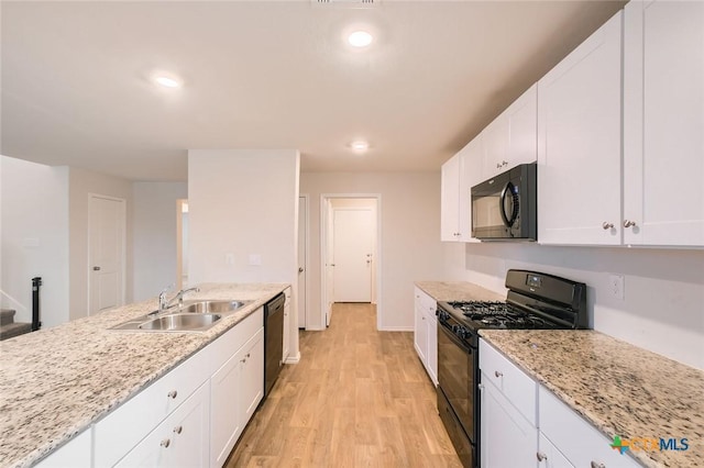 12039 Kettle Riv, San Antonio, TX 78245 - kitchen featuring black appliances, a sink, light wood-type flooring, white cabinets, and light stone countertops