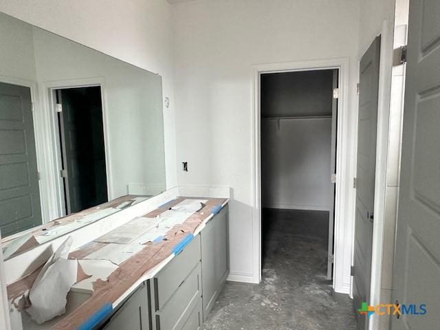 bathroom with concrete flooring and vanity