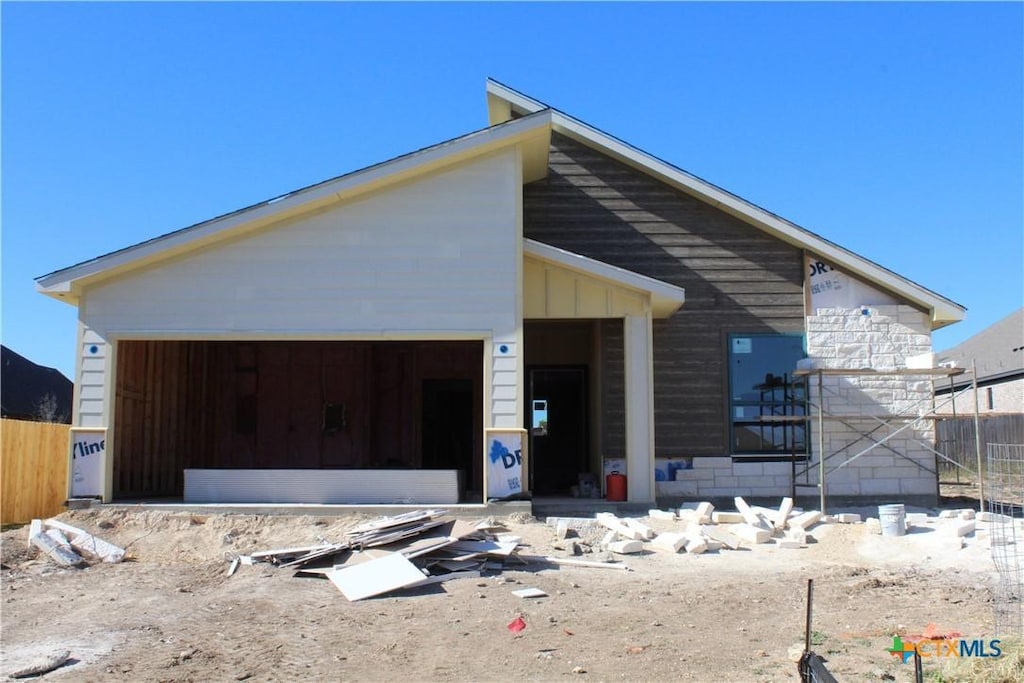 unfinished property featuring a garage