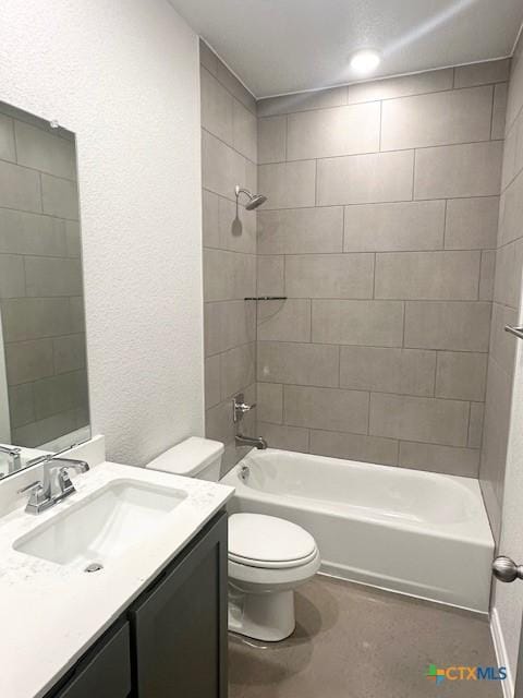 bathroom featuring washtub / shower combination, a textured wall, toilet, vanity, and concrete flooring