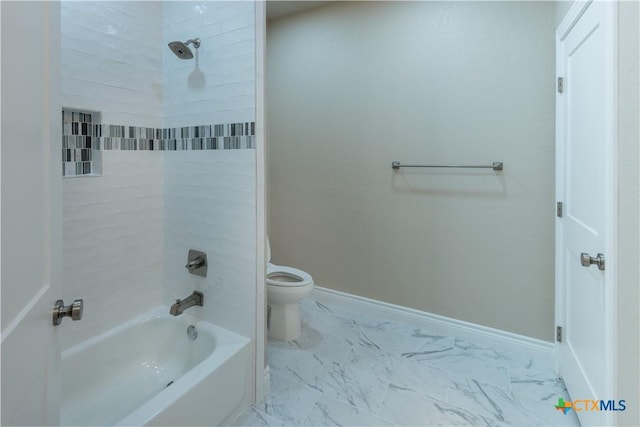 bathroom with marble finish floor, toilet, shower / tub combination, and baseboards