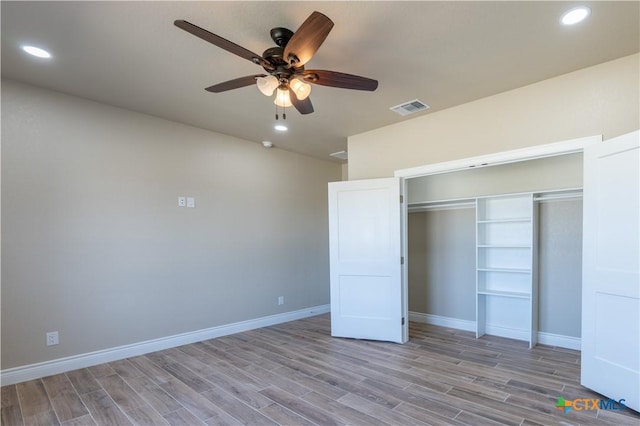 unfurnished bedroom with visible vents, baseboards, recessed lighting, wood finished floors, and a closet