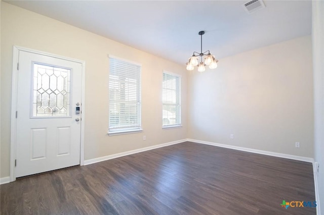 foyer with a chandelier and dark hardwood / wood-style floors