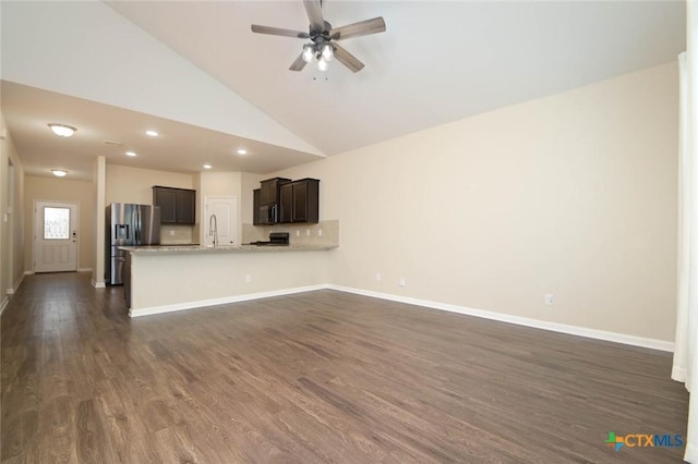 unfurnished living room with high vaulted ceiling, sink, dark hardwood / wood-style floors, and ceiling fan